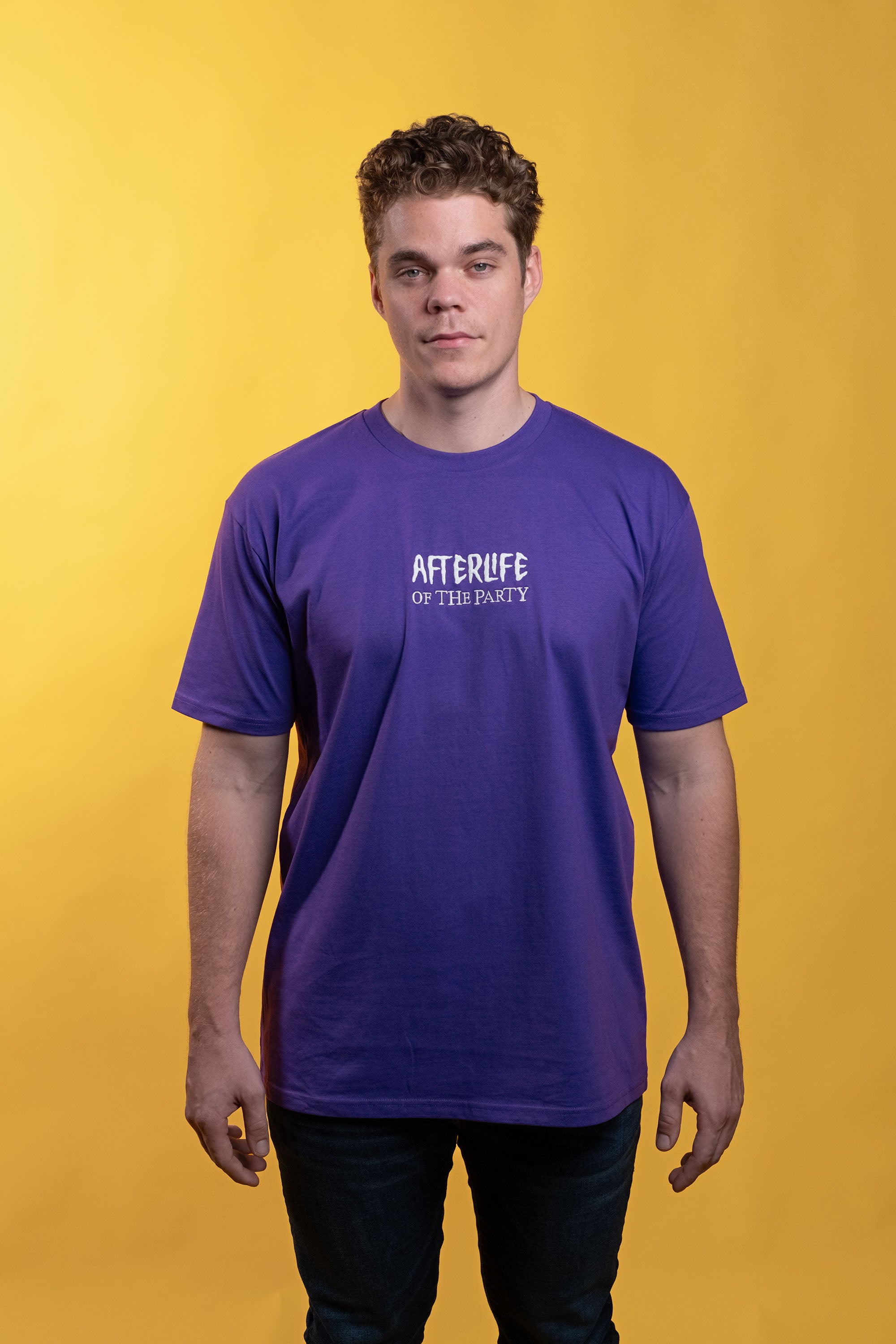 Purple preshrunk cotton t-shirt with glow-in-the-dark 'Afterlife' embroidery, printed graphic of tailgating skeletons