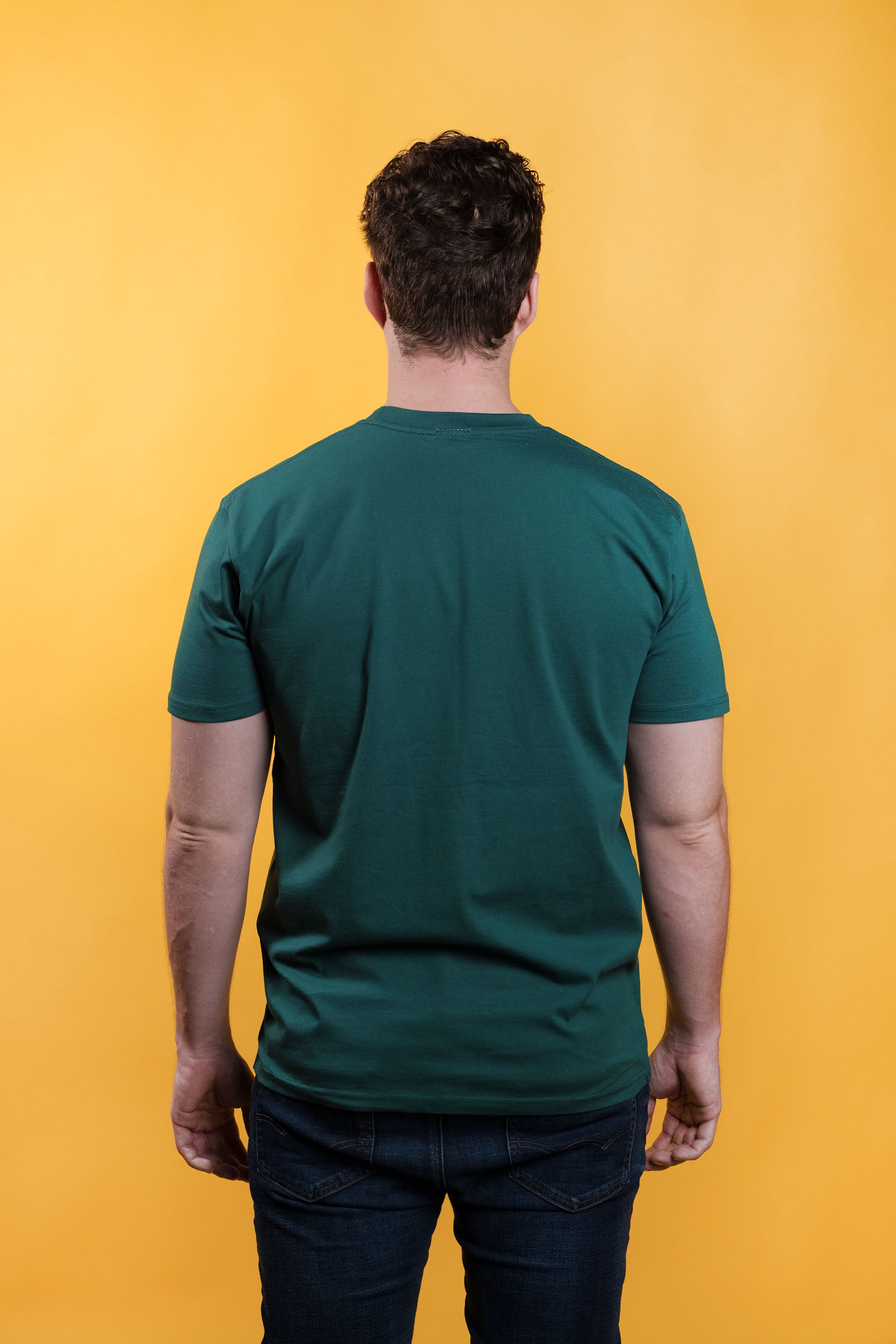 Preshrunk green cotton t-shirt with 'Kinda Childish' embroidered in an arch design