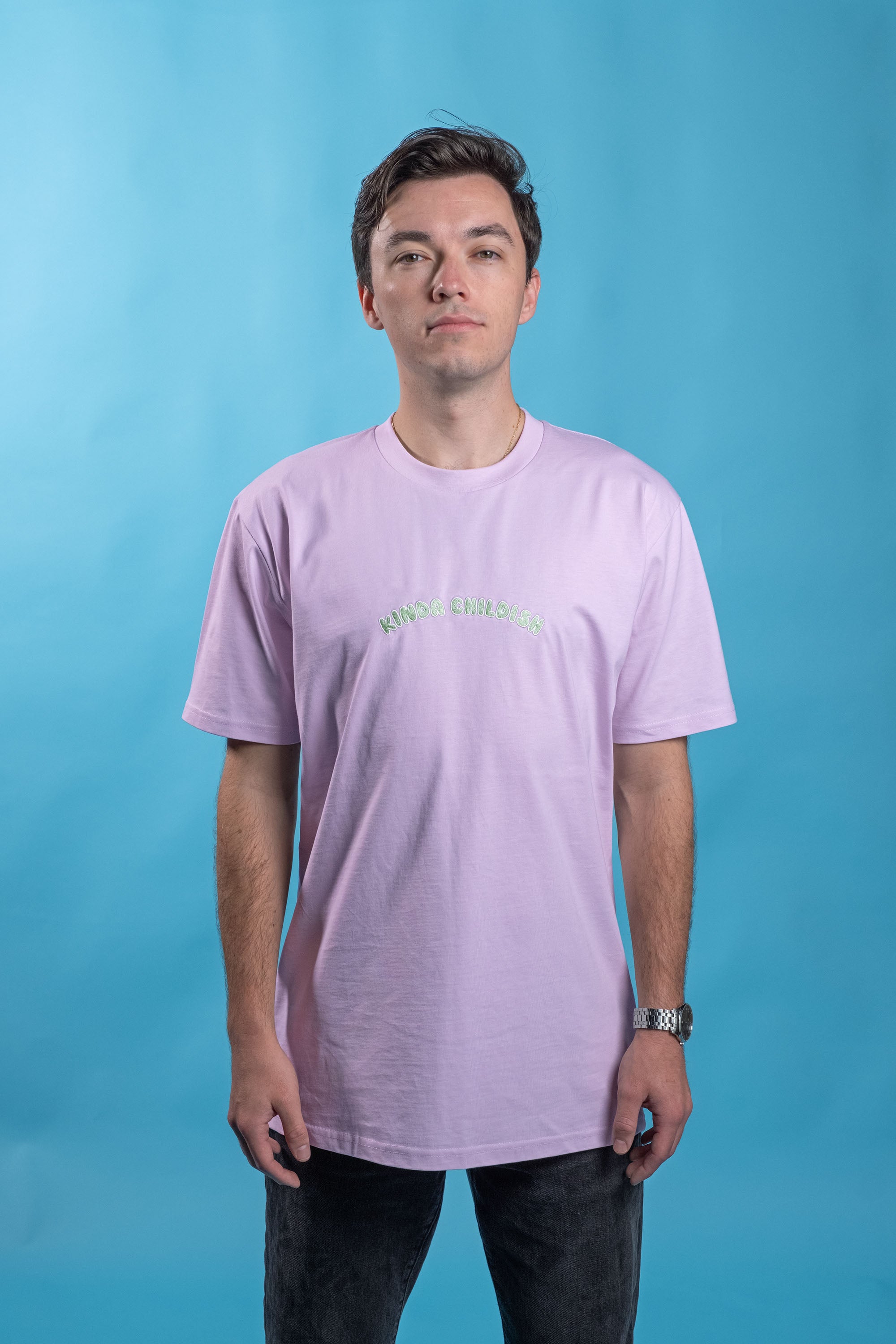 Preshrunk lilac cotton t-shirt with 'Kinda Childish' embroidered in an arch design