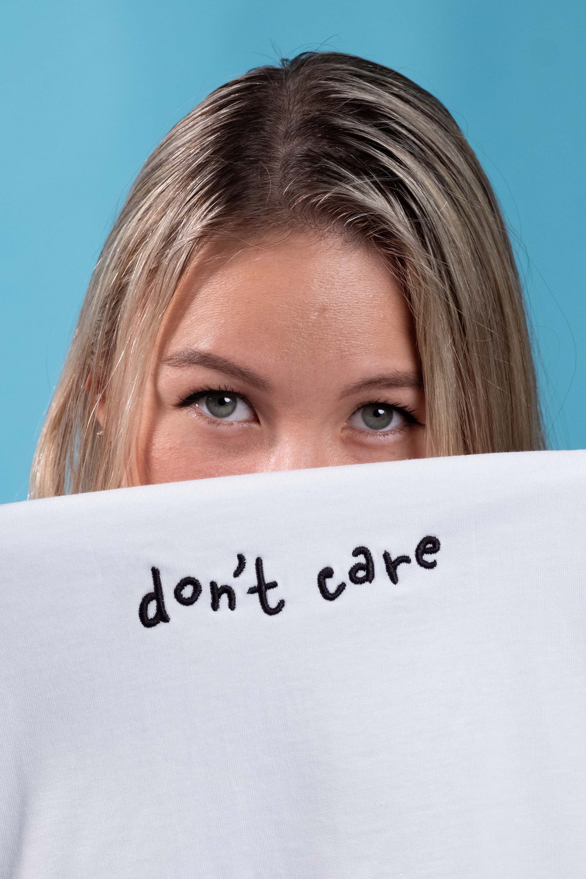Preshrunk white cotton t-shirt with 'Don't Care' embroidery, puff printing, screen print details