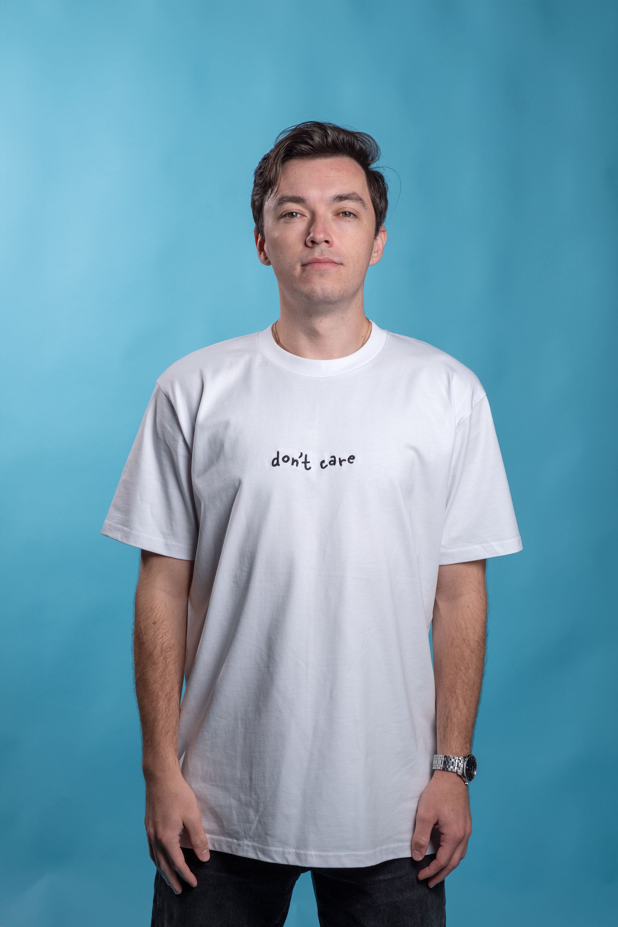 Preshrunk white cotton t-shirt with 'Don't Care' embroidery, puff printing, screen print details