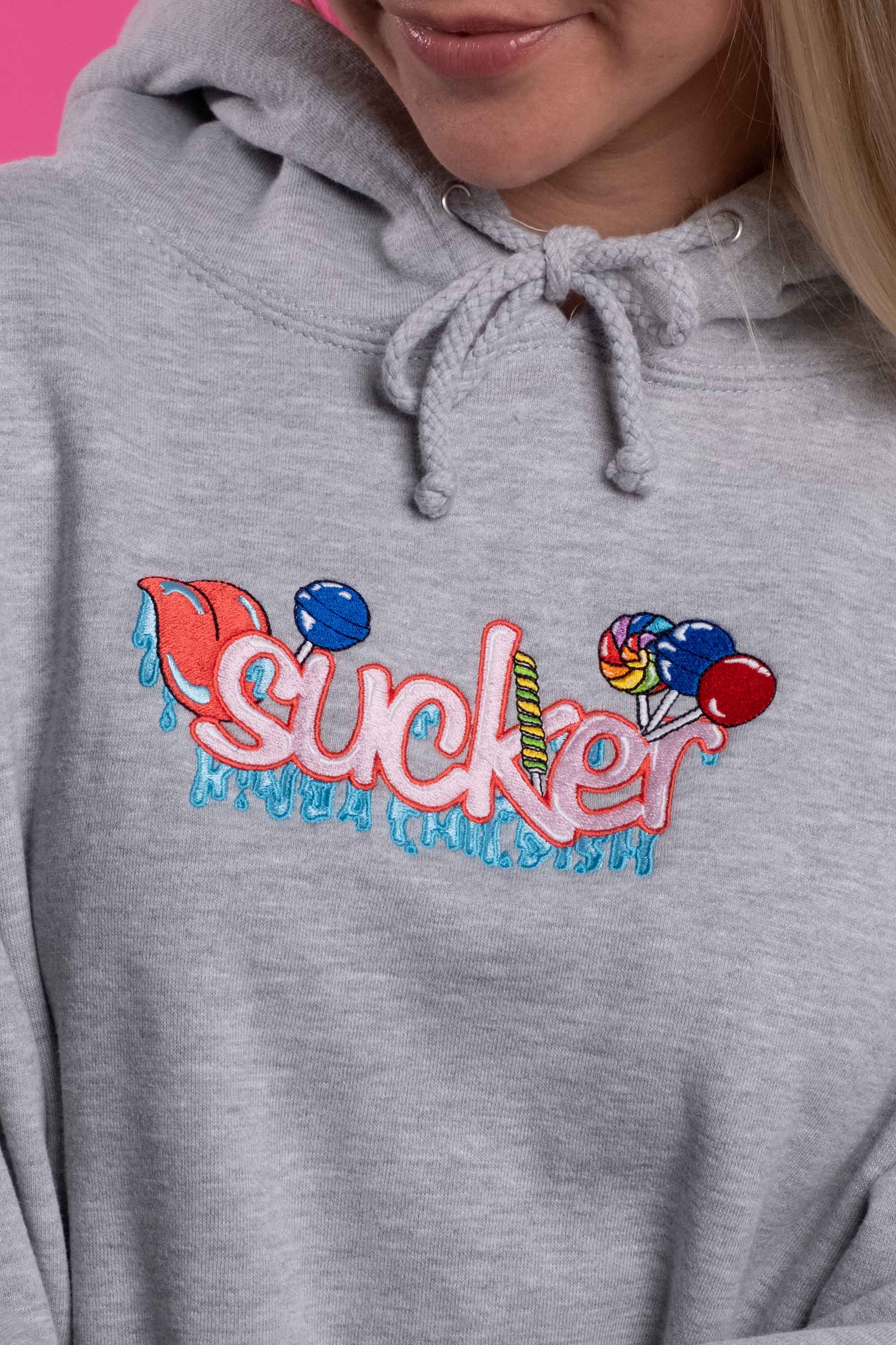 Grey cotton-polyester blend hoodie with an embroidered design of the word 'sucker' and colorful lollipops