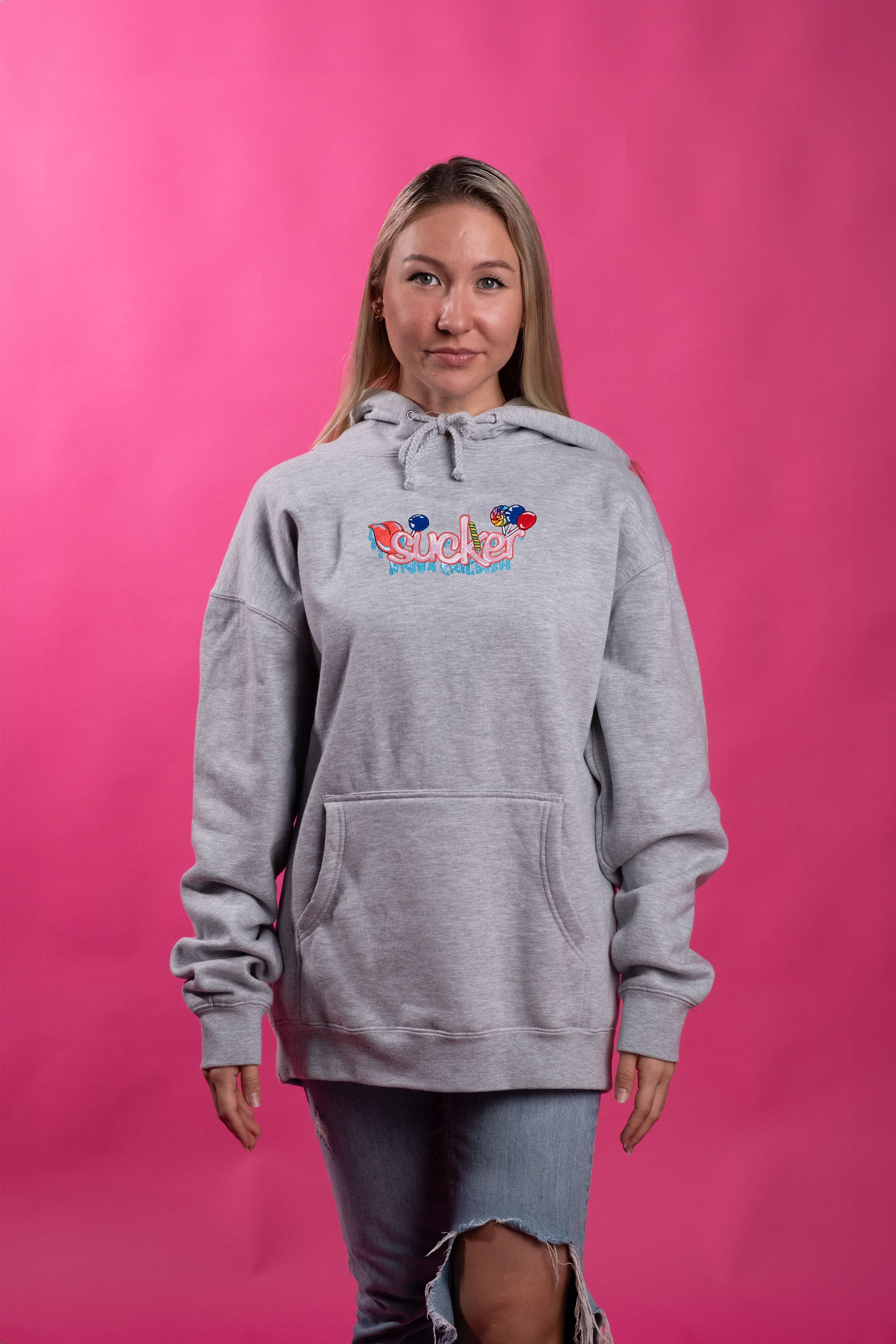 Grey cotton-polyester blend hoodie with an embroidered design of the word 'sucker' and colorful lollipops