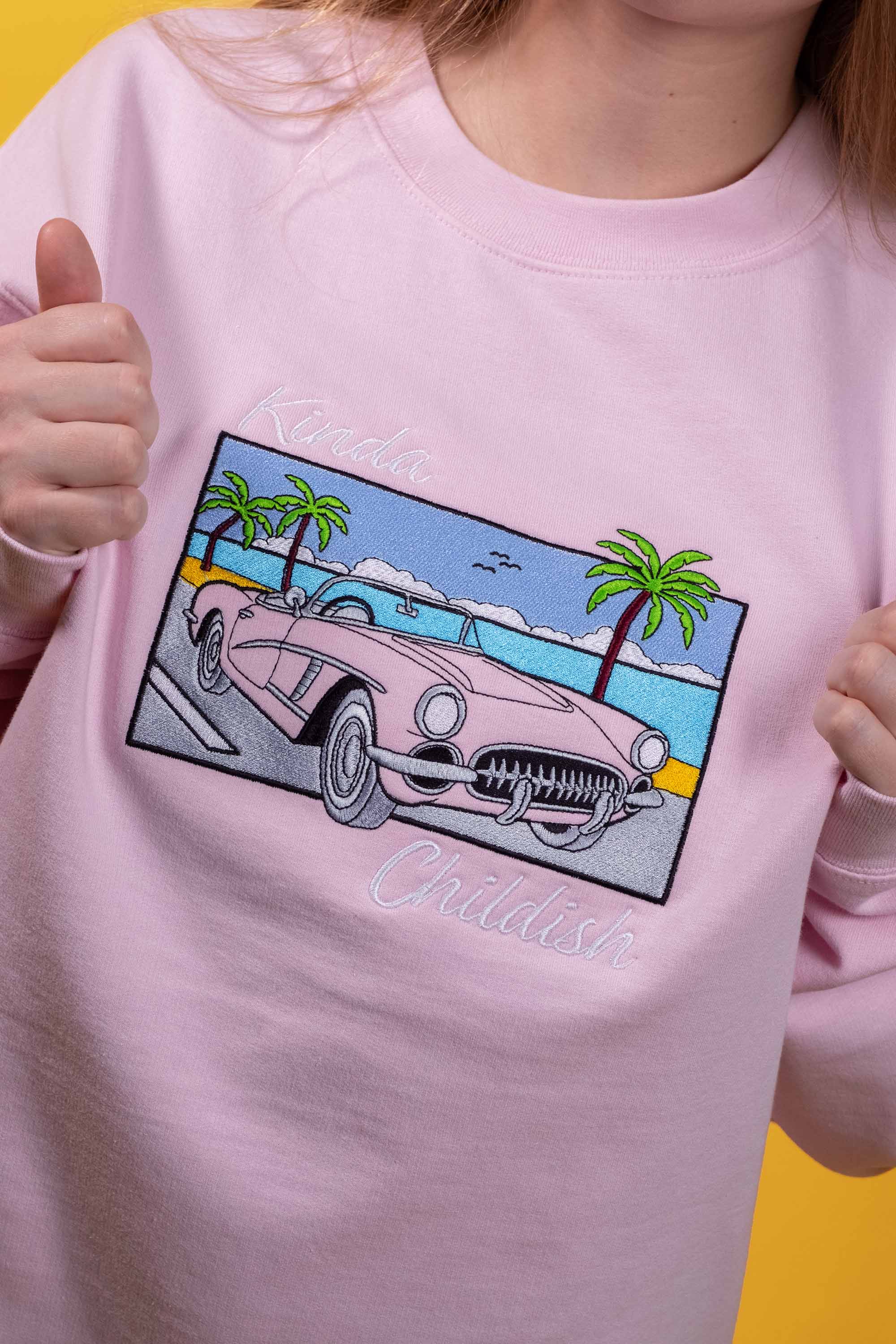 Pink cotton-polyester blend crewneck sweatshirt cozy brushed fleece interior embroidered classic car on a beach