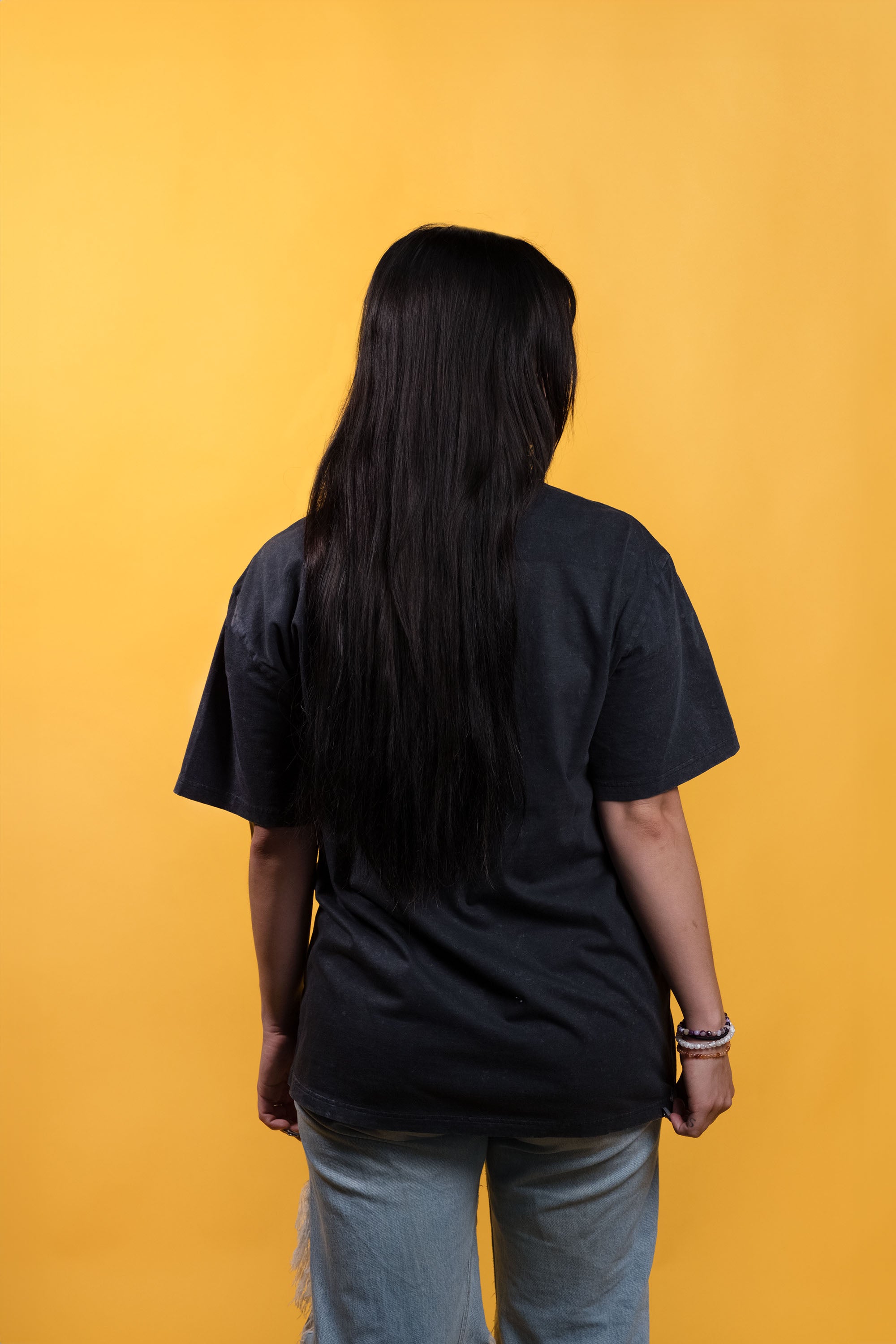 Stone-wash black preshrunk cotton t-shirt with a graphic of a woman smoking Smarties and 'Nostalgia Junkie' text