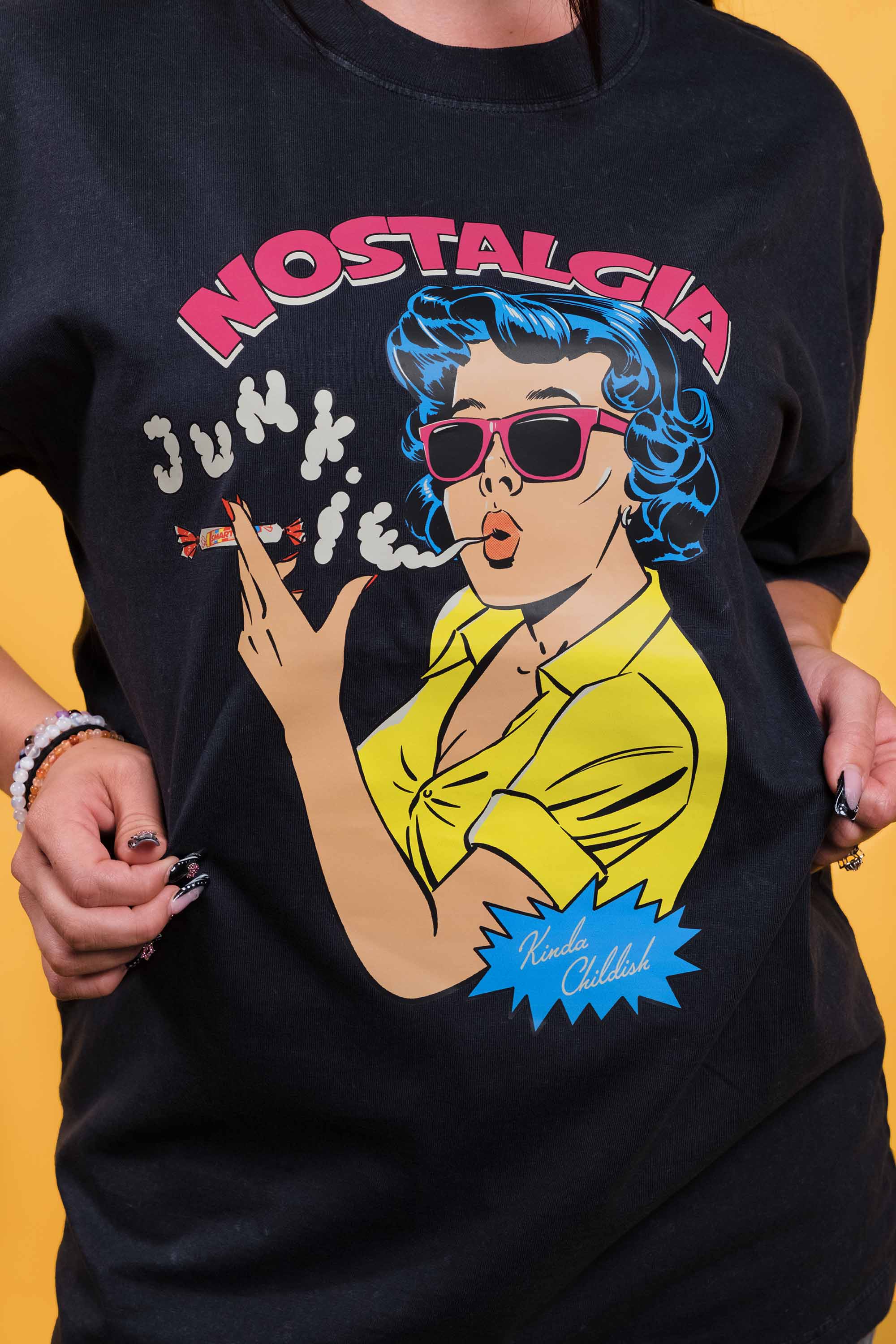 Stone-wash black preshrunk cotton t-shirt with a graphic of a woman smoking Smarties and 'Nostalgia Junkie' text