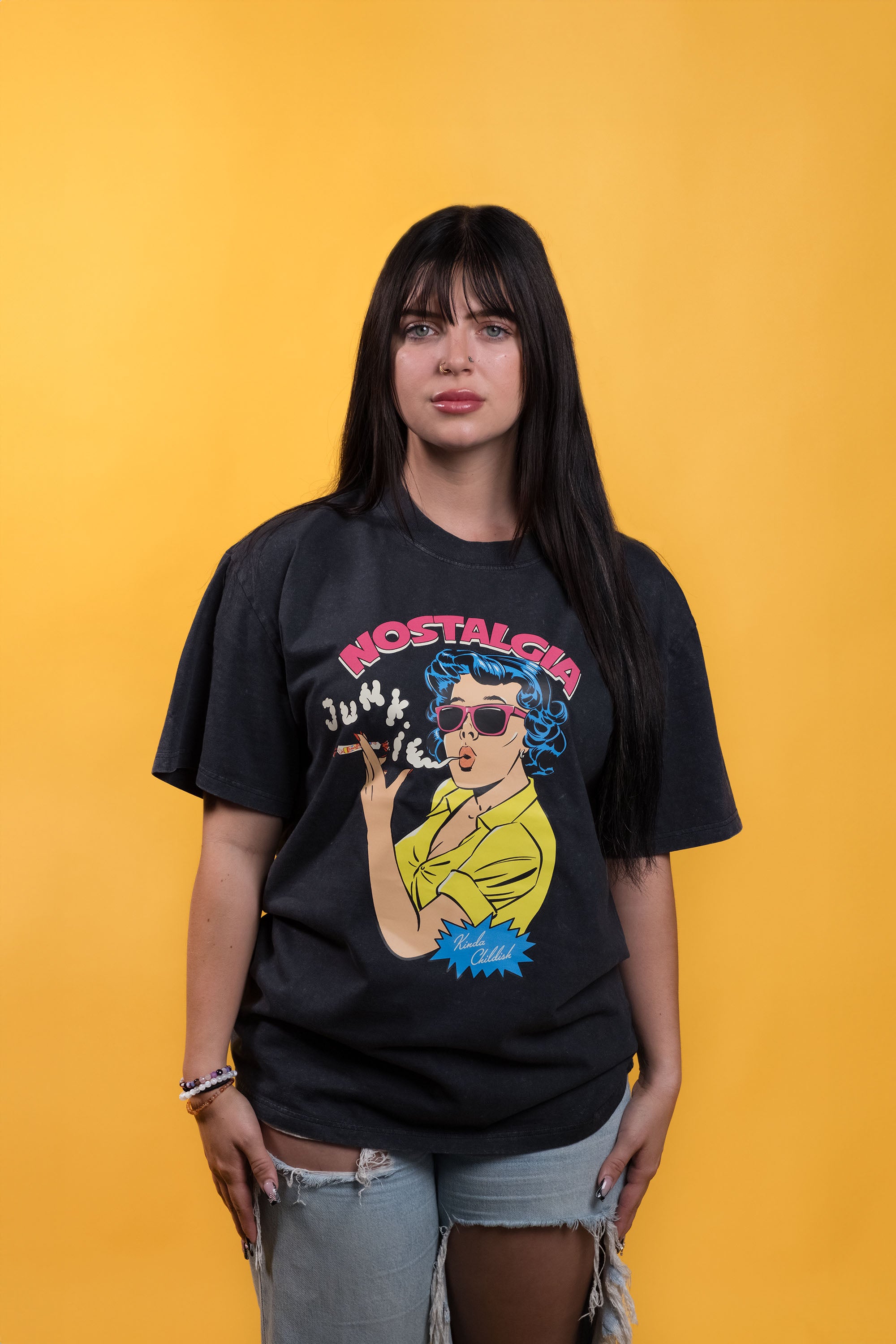 Stone-wash black preshrunk cotton t-shirt with a graphic of a woman smoking Smarties and 'Nostalgia Junkie' text