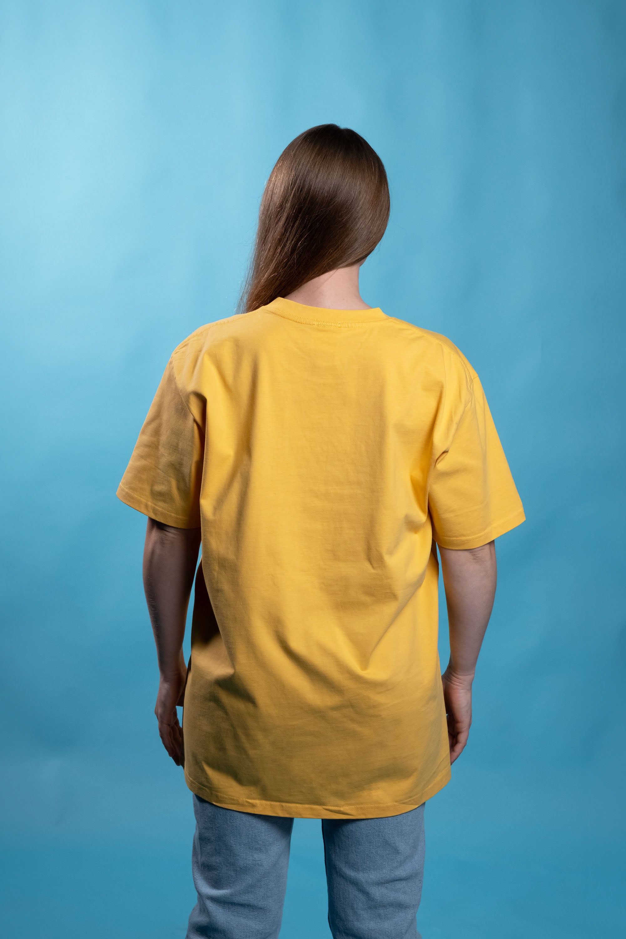 Preshrunk yellow cotton t-shirt with 'growing up is for quitters' embroidered design