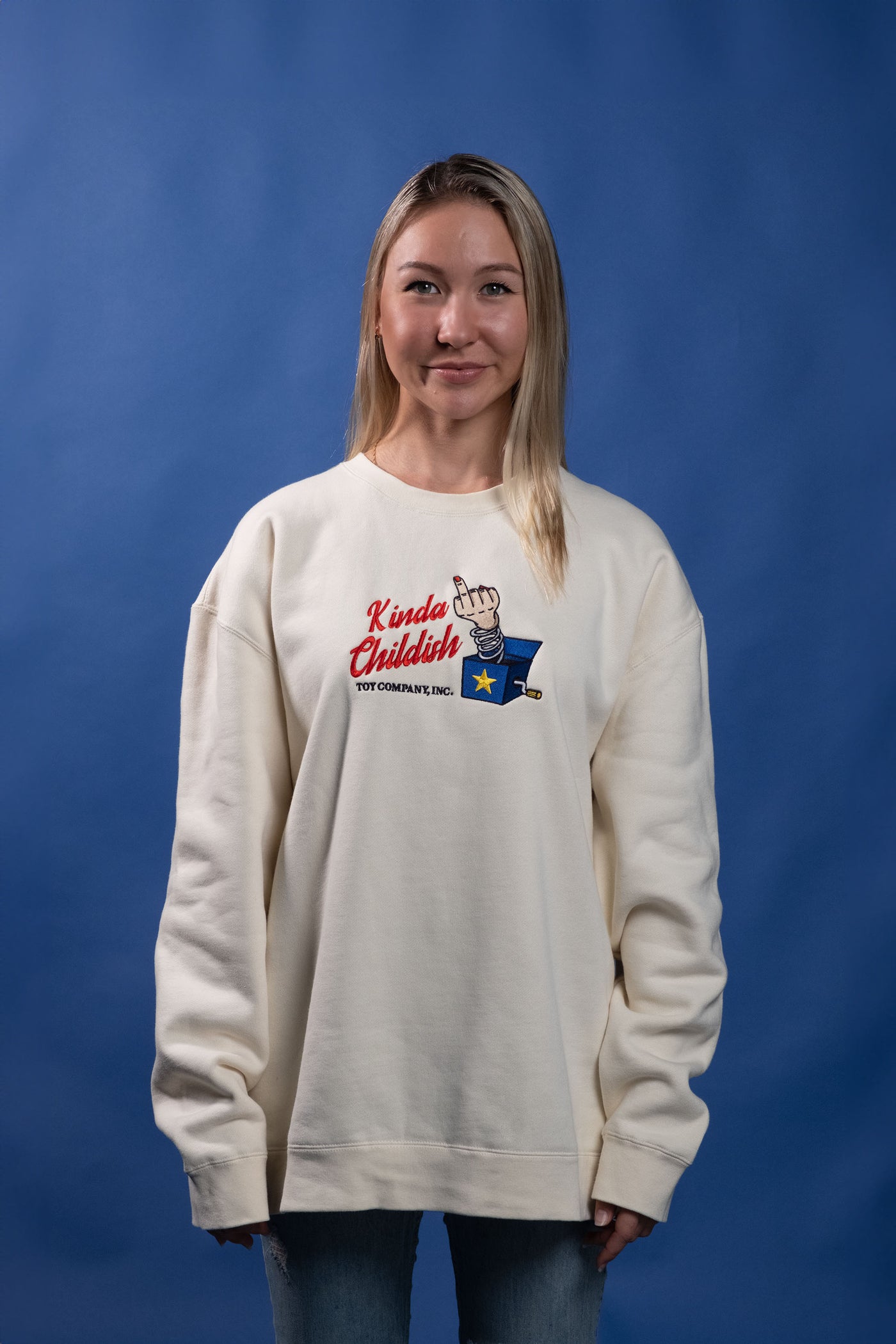 Ivory cotton-polyester blend sweatshirt with an embroidered design of a middle finger popping out of a jack-in-the-box