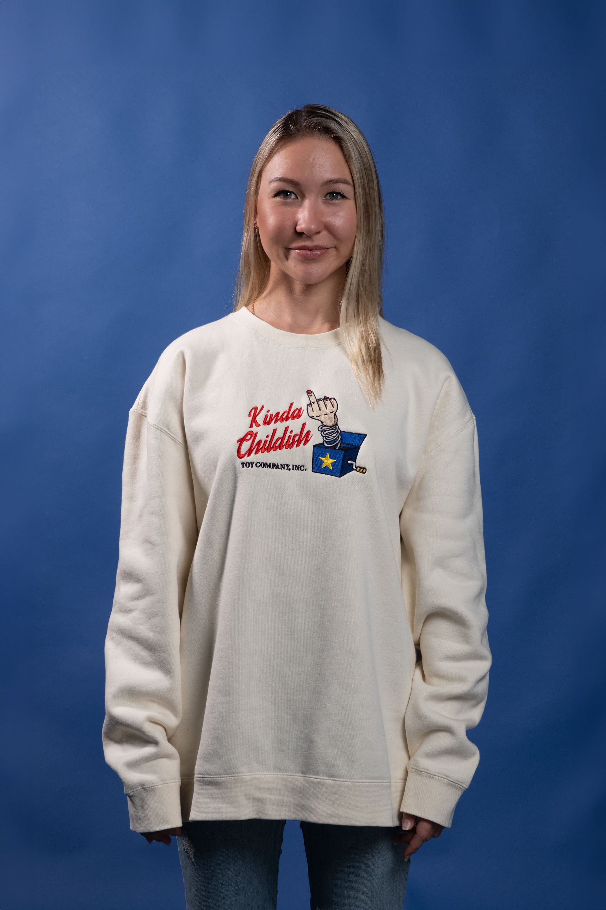 Ivory cotton-polyester blend sweatshirt with an embroidered design of a middle finger popping out of a jack-in-the-box